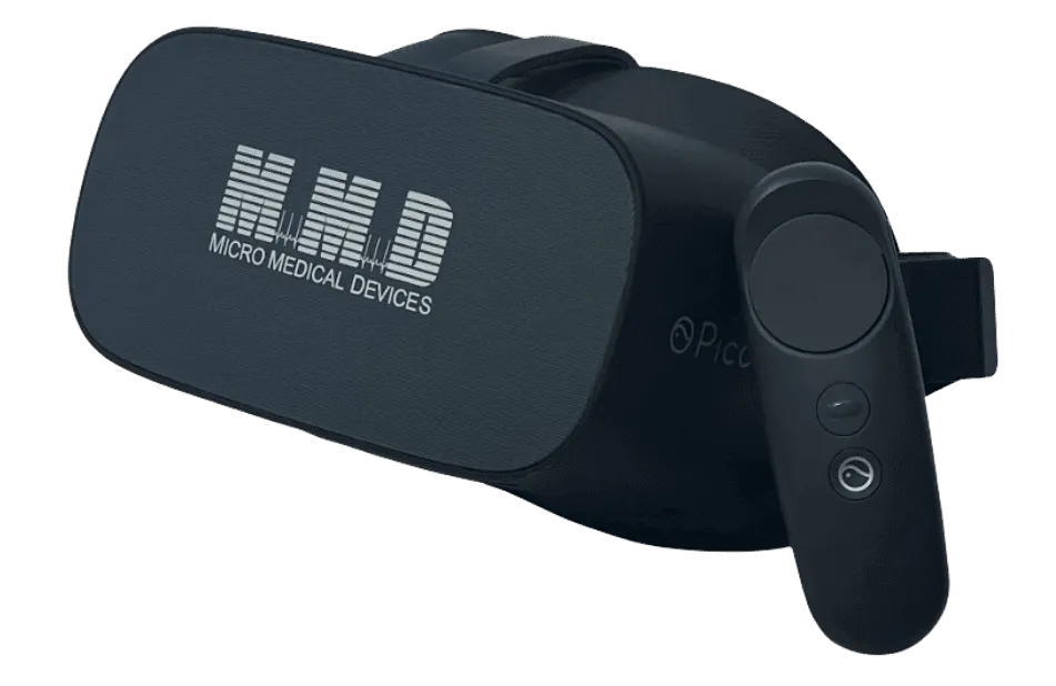 A black virtual reality headset labeled MMD Micro Medical Devices with an attached adjustable strap and a handheld controller featuring two buttons.
