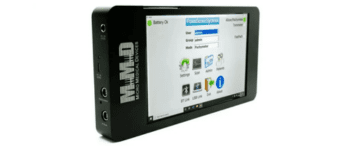 A black rectangular electronic device displaying a user interface on its screen, labeled NAND Multi Media Device on the side, with various ports visible on the left edge.