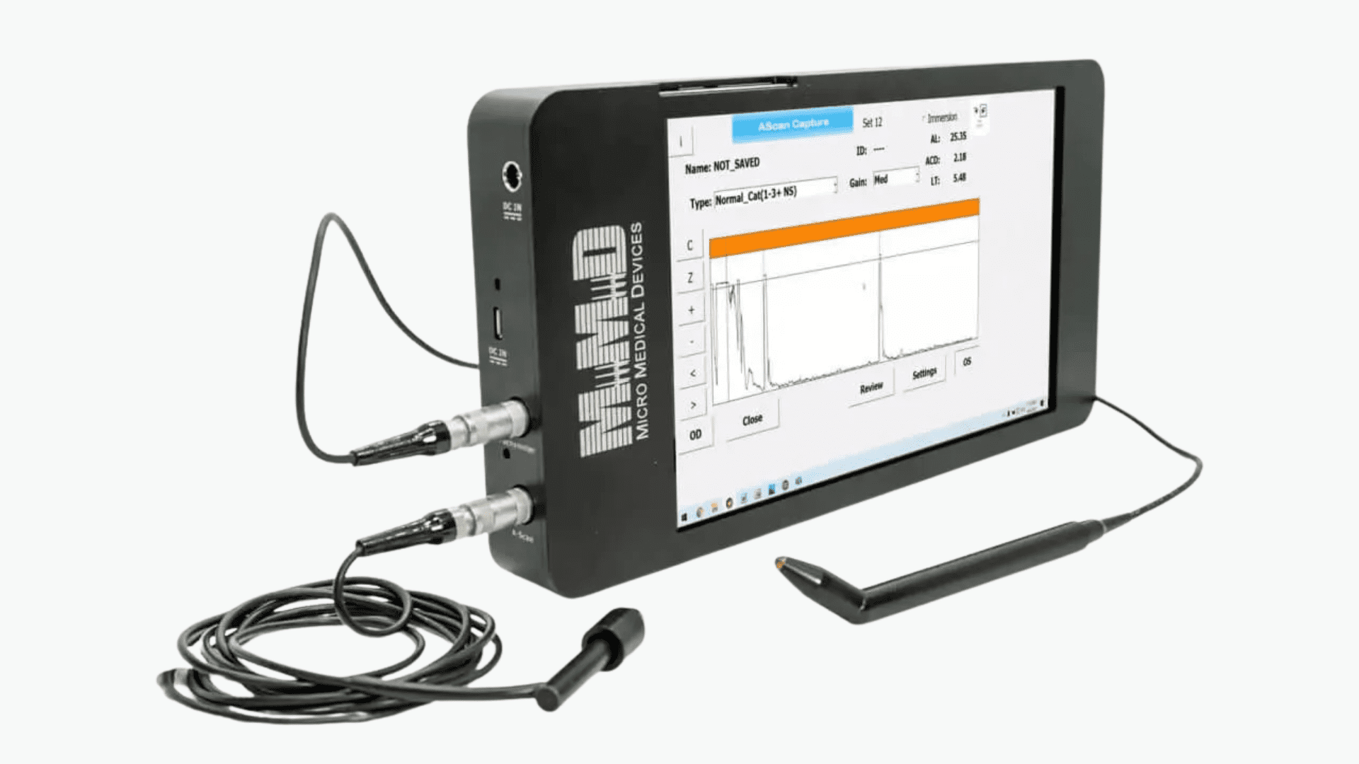 A medical device with a touchscreen displays a graph and patient data. Two cables are connected to the side, one ending in an electrode and the other in a sensor. A stylus rests nearby. The device is labeled MMMD Micro Medical Device.