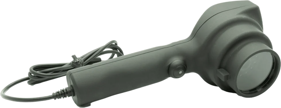 A handheld black magnifying glass with a built-in light, attached to a power cord, and featuring a power button on its handle.